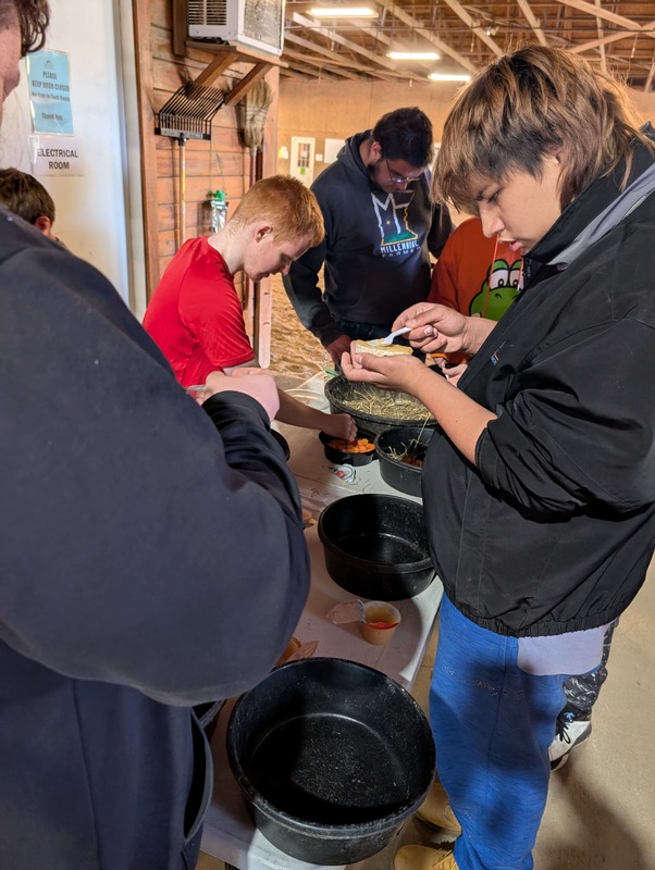 Students making  pizzas for horses