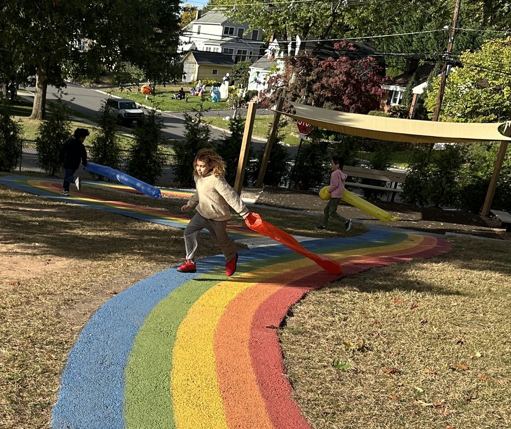 students running with wind sock