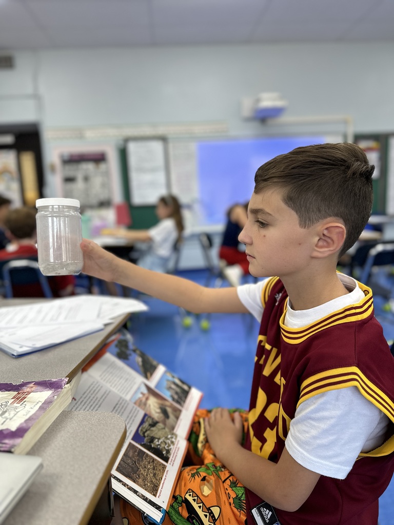 student observing rocks