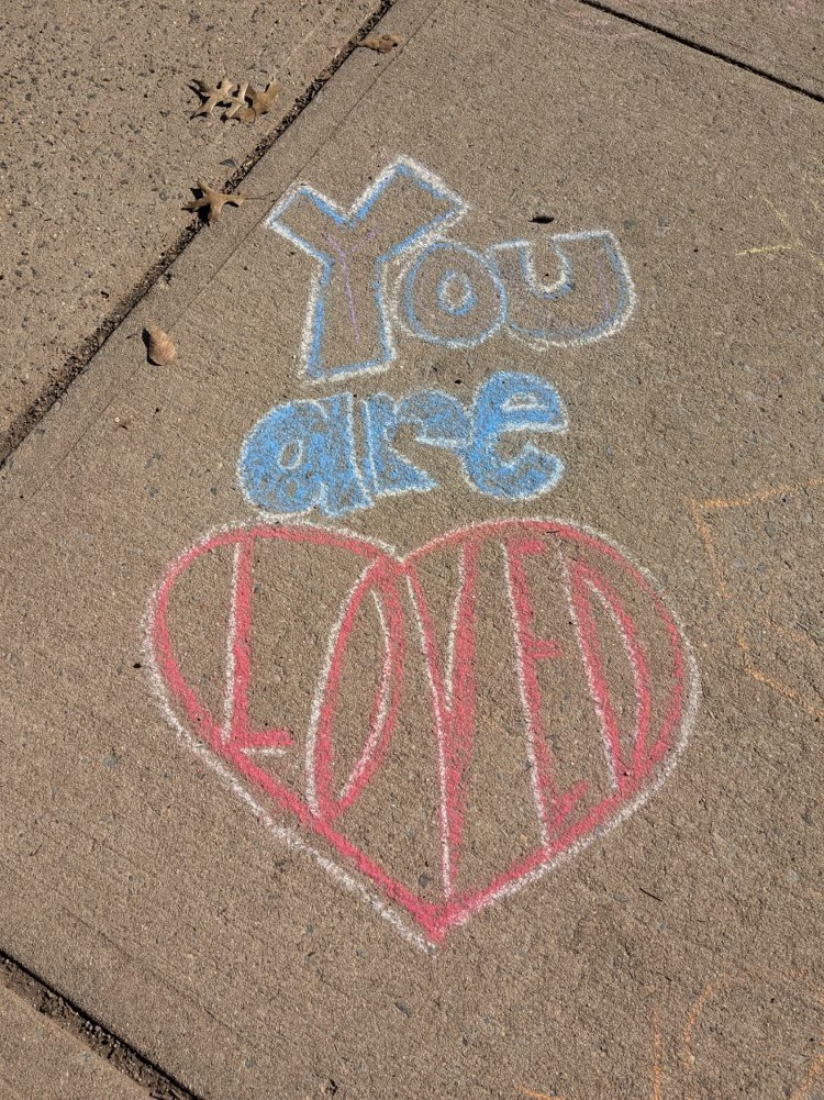 Chalked message on sidewalk
