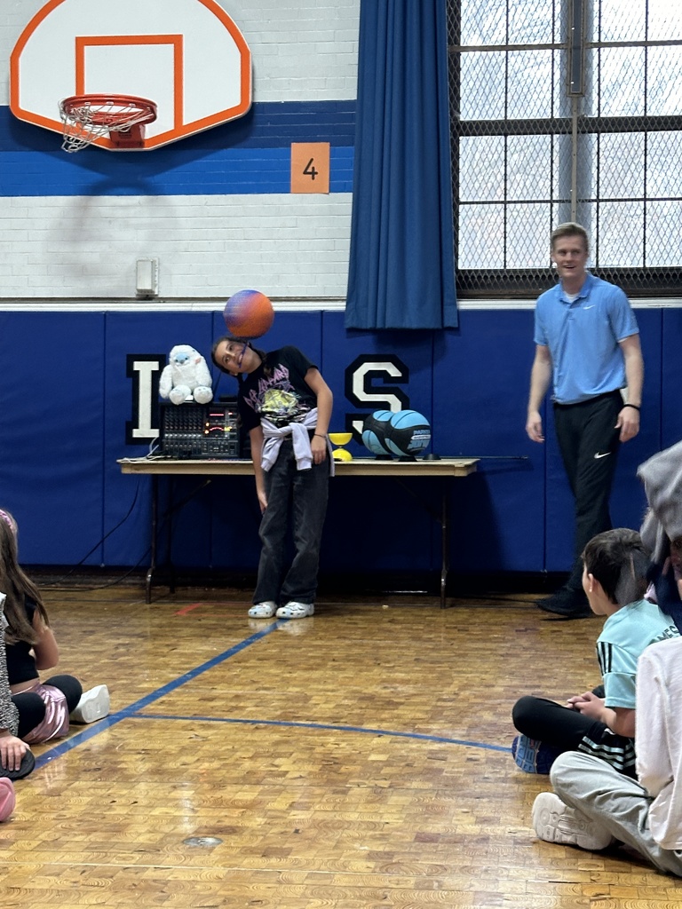 student with ball on head