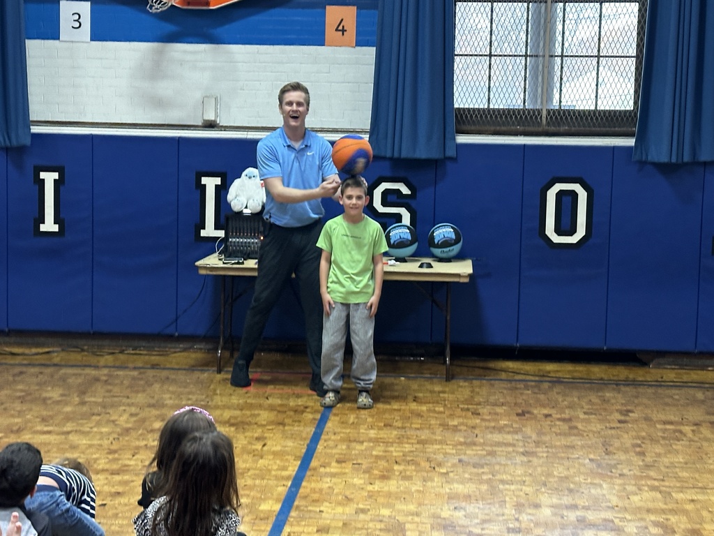 student with basketball on head