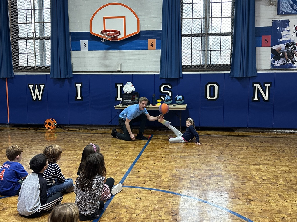 student with basketball on foot
