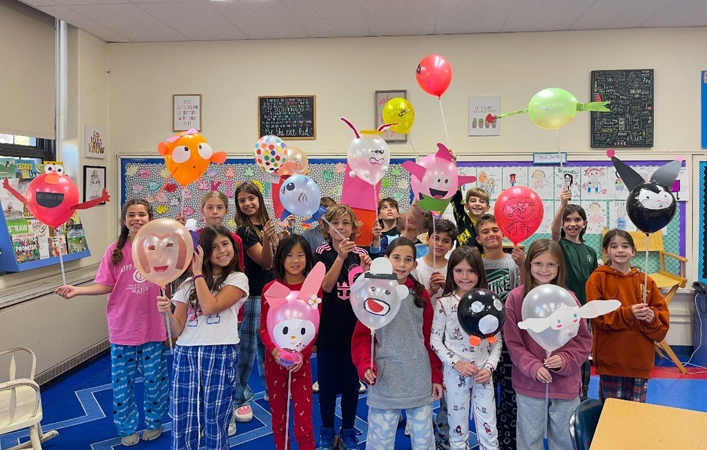 students holding their balloon designs