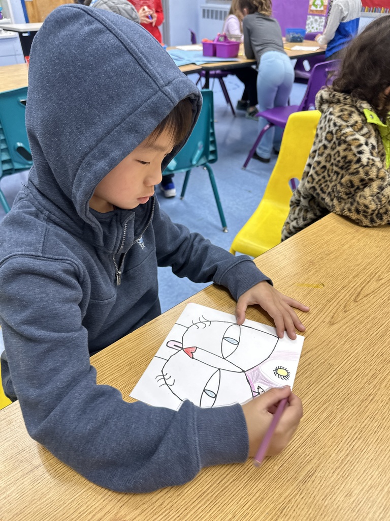 student working on their Cat and Bird art
