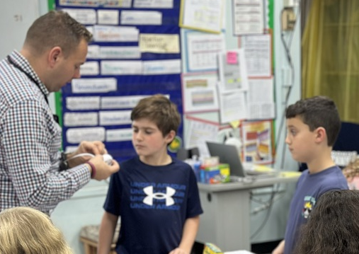 Teacher works with 3rd graders duing science lesson