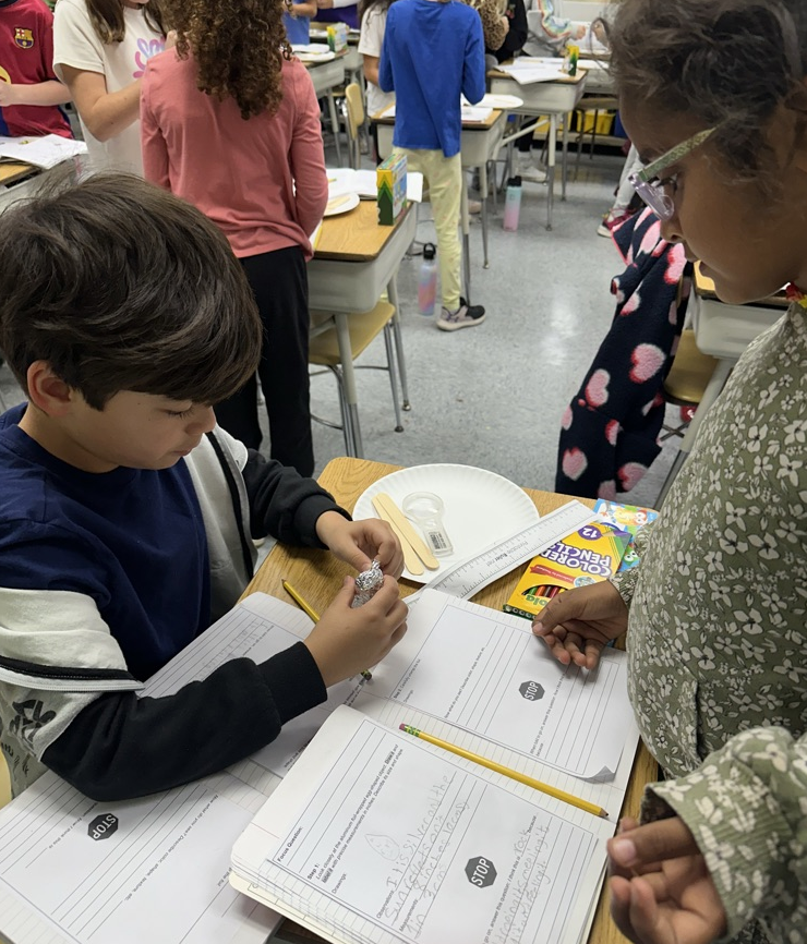Two 3rd graders work on science lesson together
