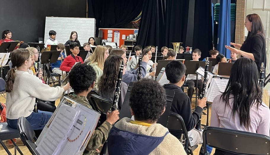 Jefferson band director conducts students on stage during concert