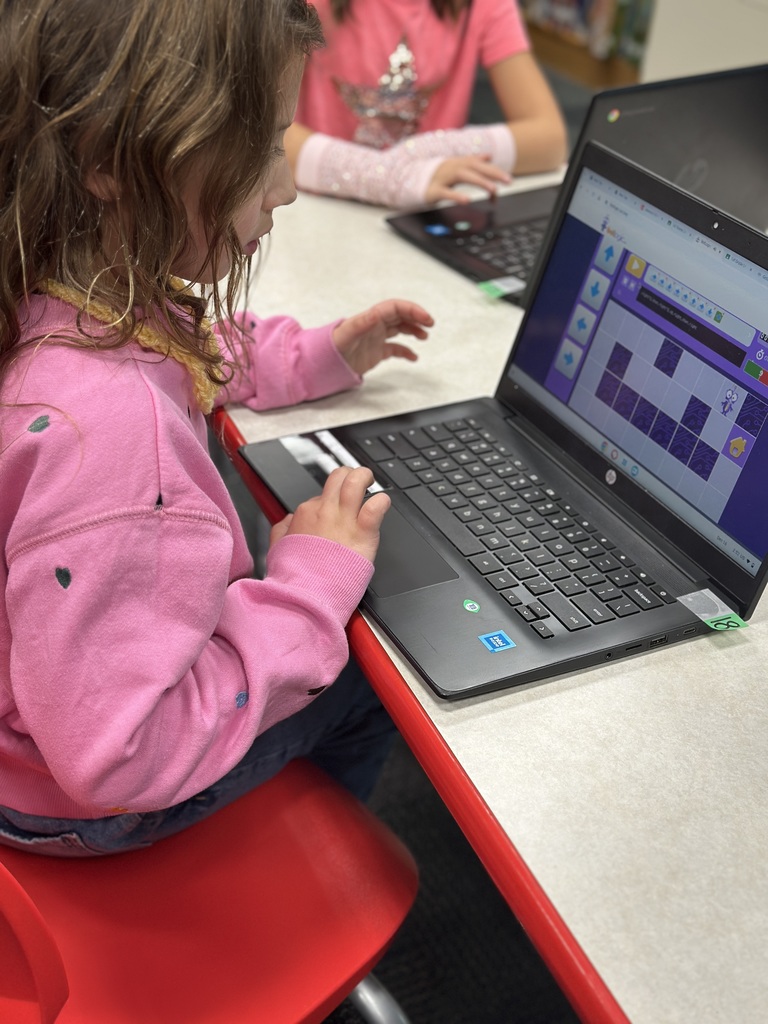 first grade student playing coding game