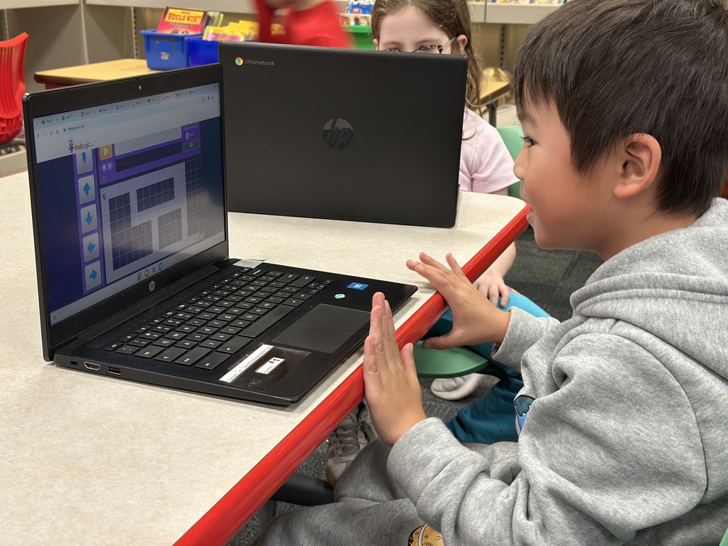 first grade student playing coding game