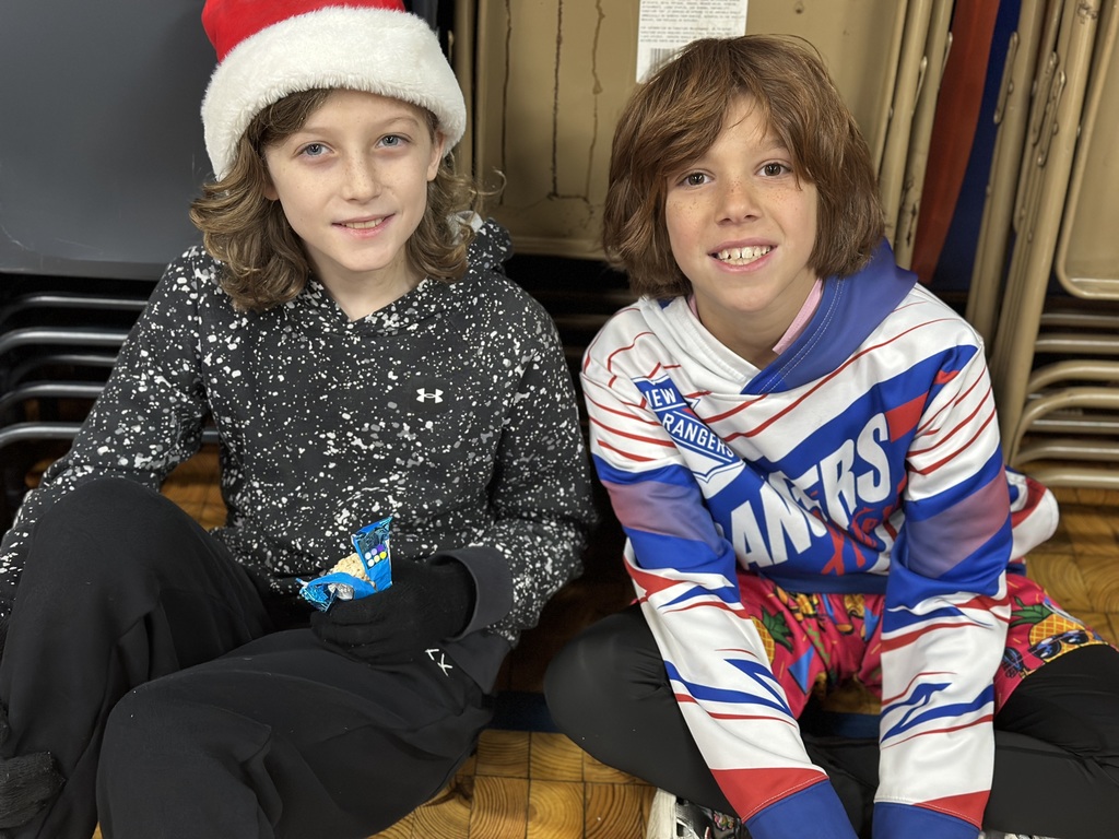 5th grade students sitting in the gym after performance