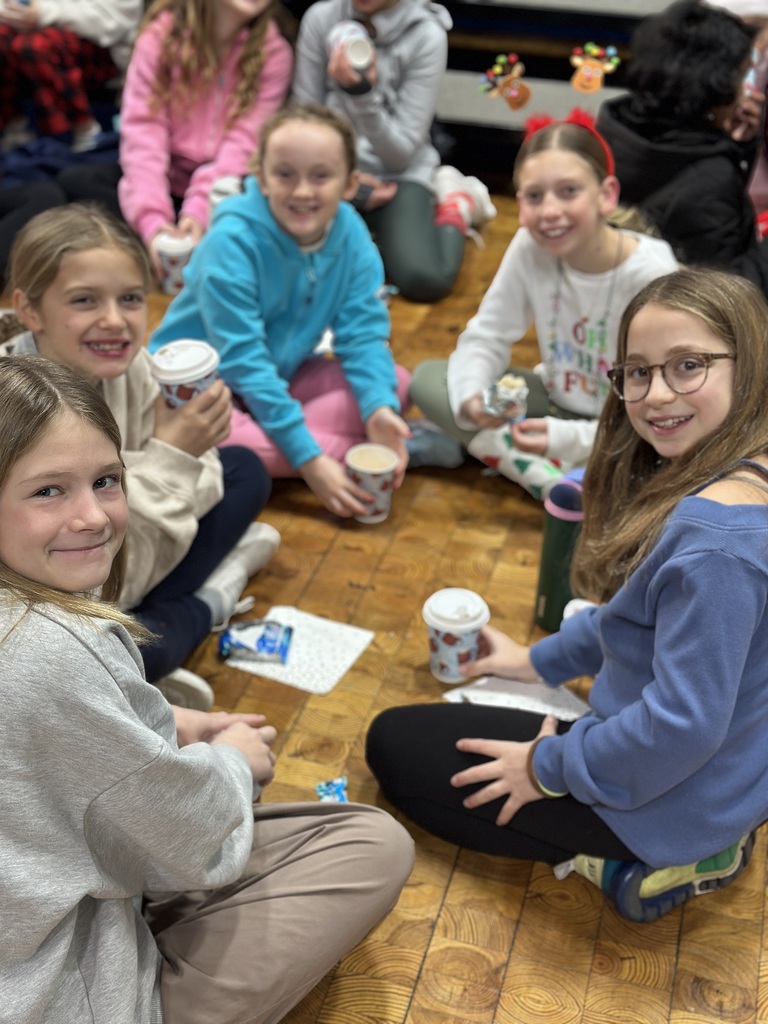 5th grade students sitting in the gym after performance