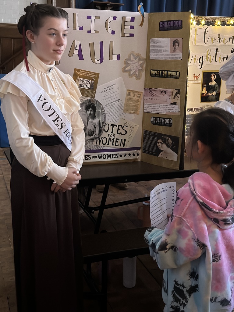 5th grade student talking to younger student