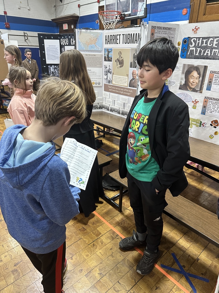 5th grade student talking to younger student