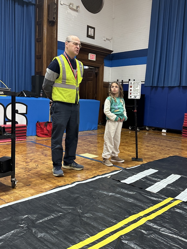 second grade girl practicing crossing the street