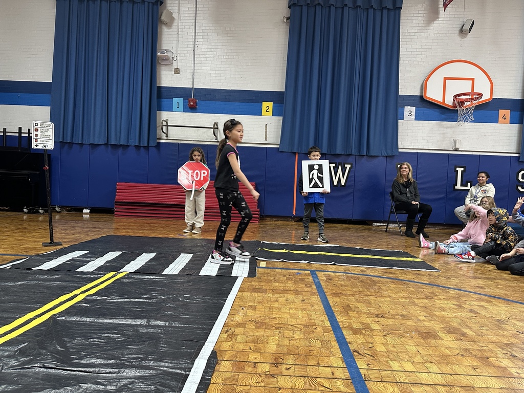 second grade girl practicing crossing the street