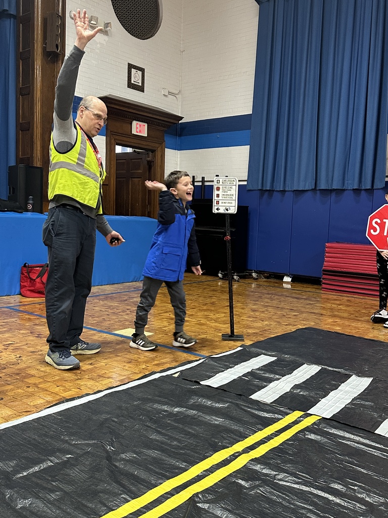 second grade boy practicing crossing the street