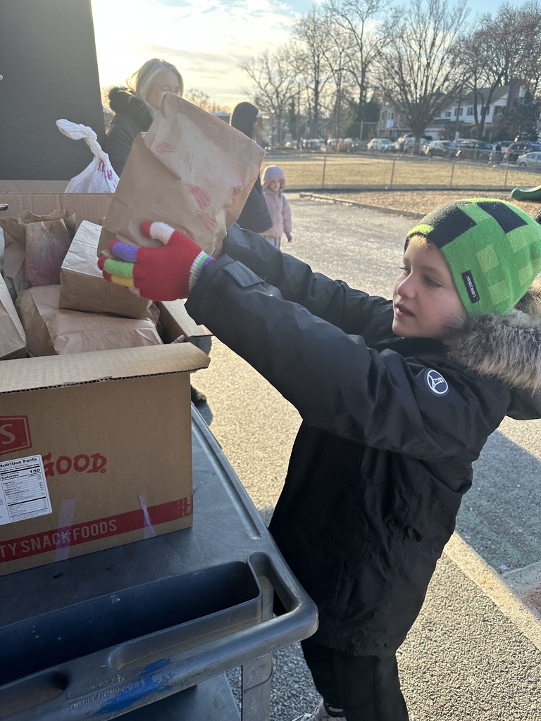 student placing lunch in donation box