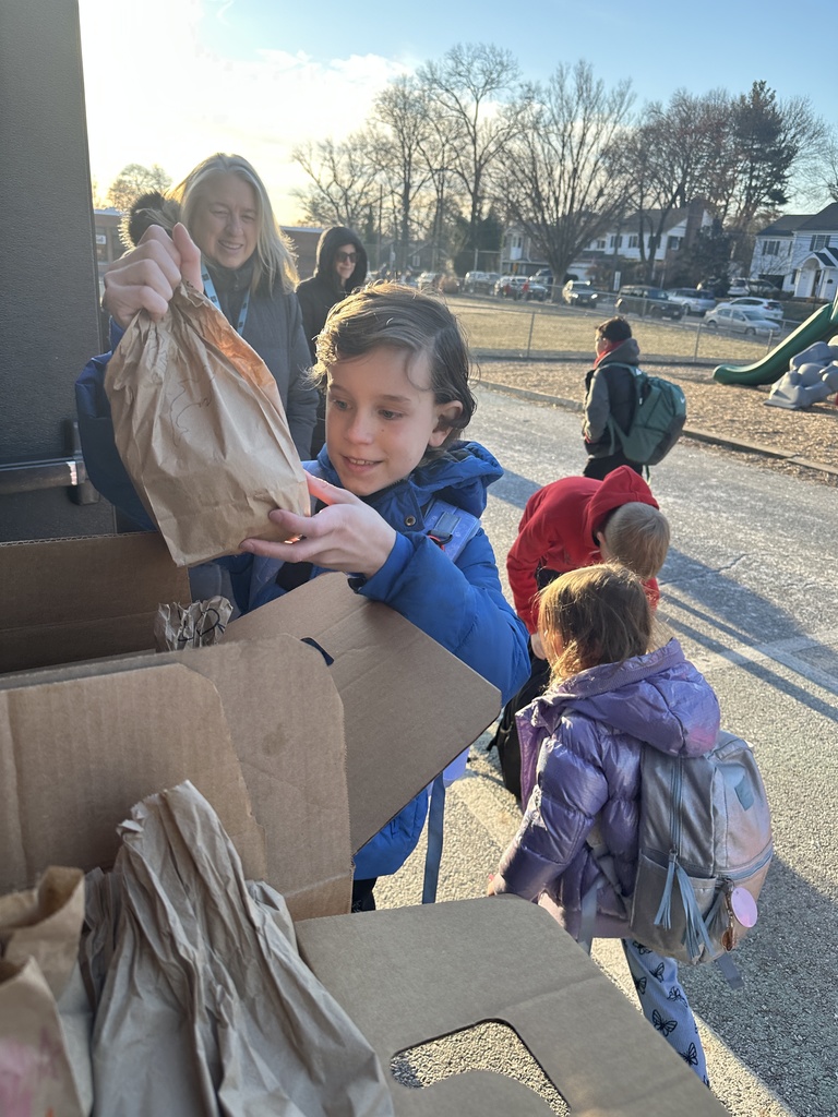 student placing lunch in donation box