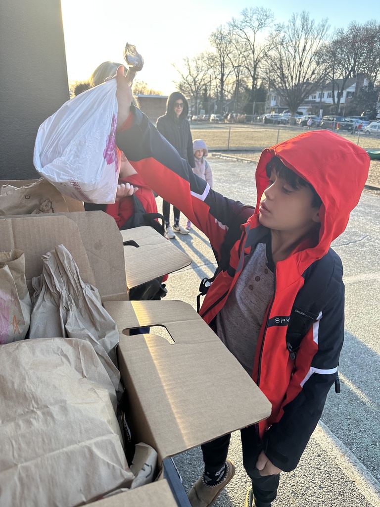 student placing lunch in donation box