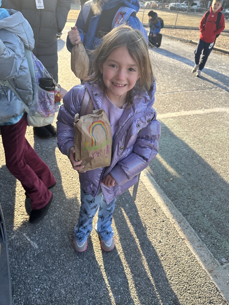 student holding a lunch to be donated