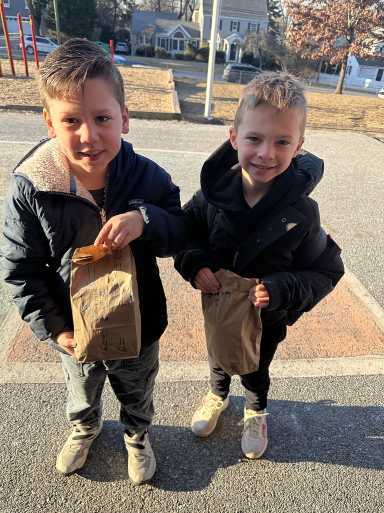 students holding lunches to be donated