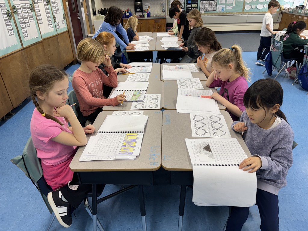 Students look at published books and writes a note for the author. 