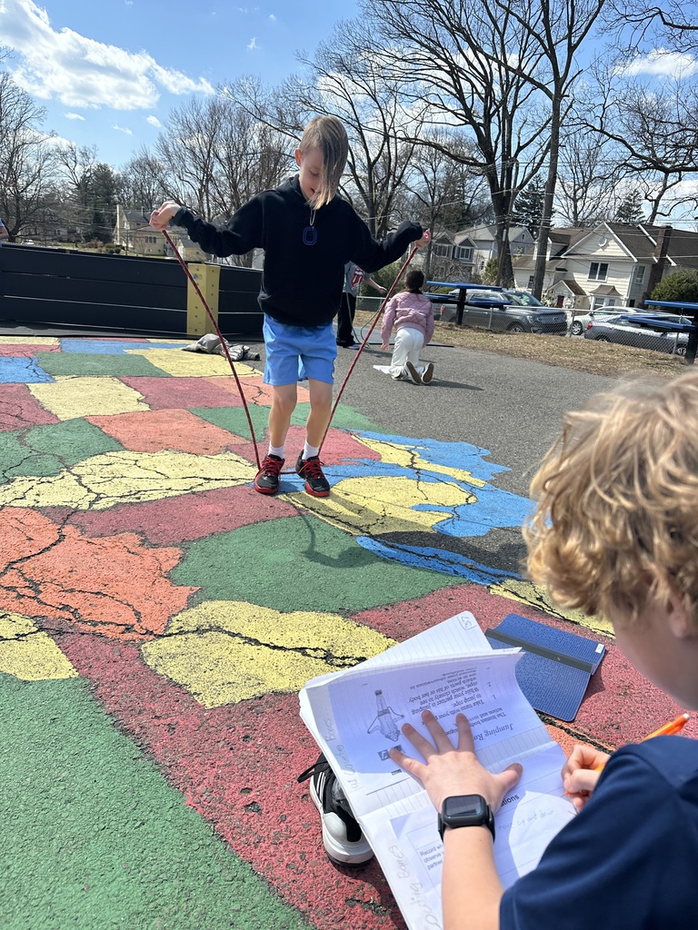 student preparing to jump rope with partner observing