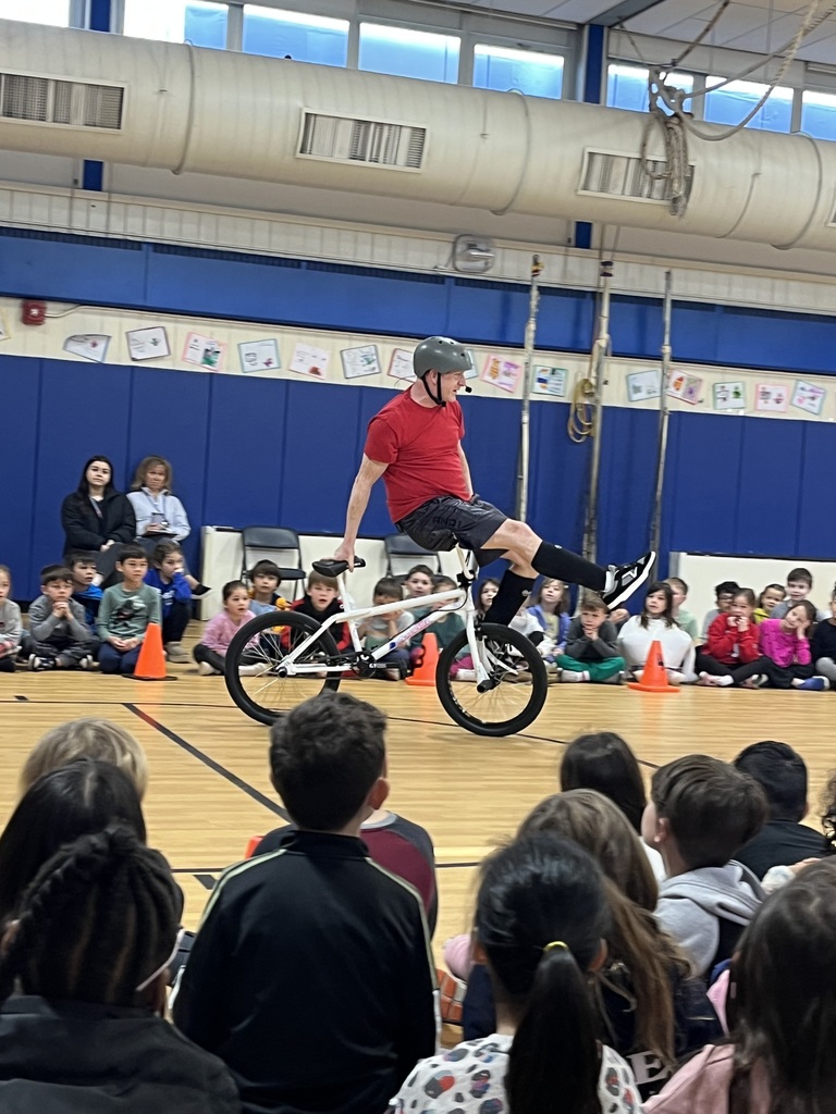The presenter is doing a stunt on his bike.