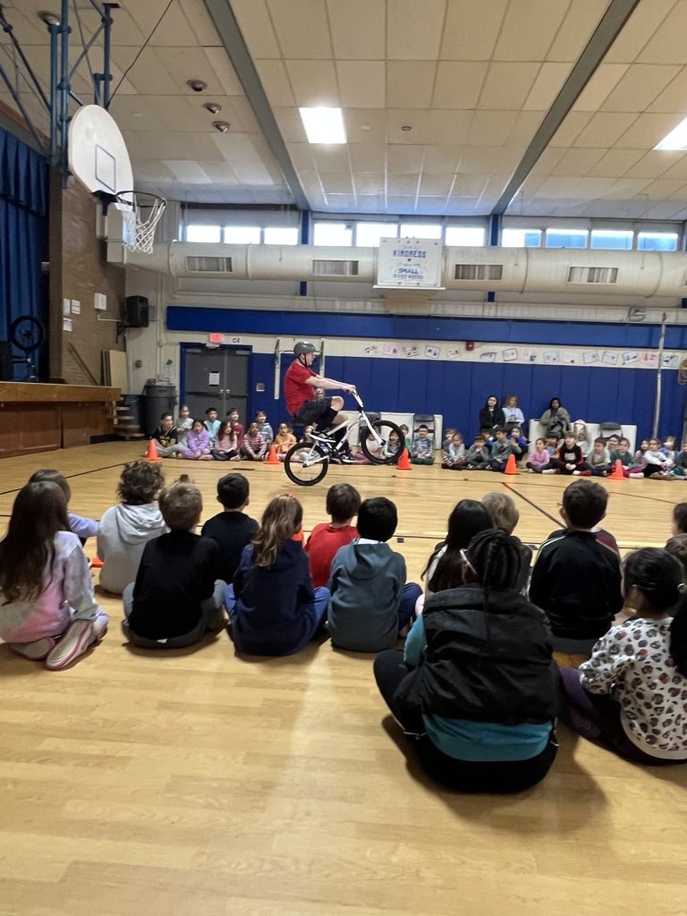 The presenter is doing a stunt on his bike.