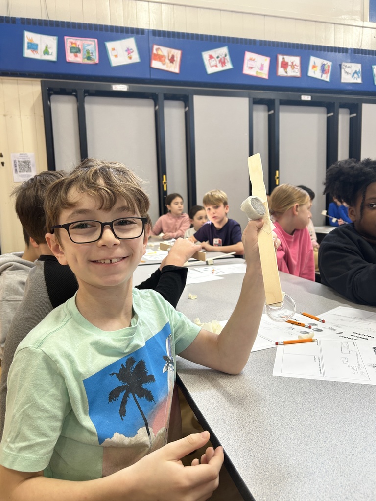 Student shows off his catapult.