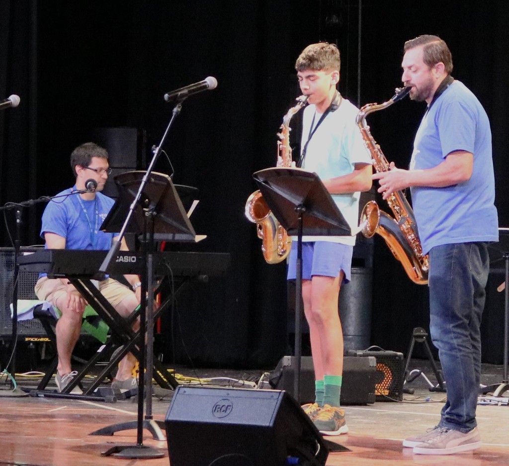 Student and instructor play instrument