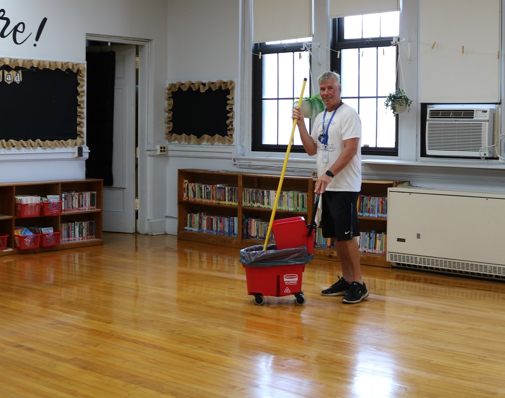 McKinley staffer cleaning floors