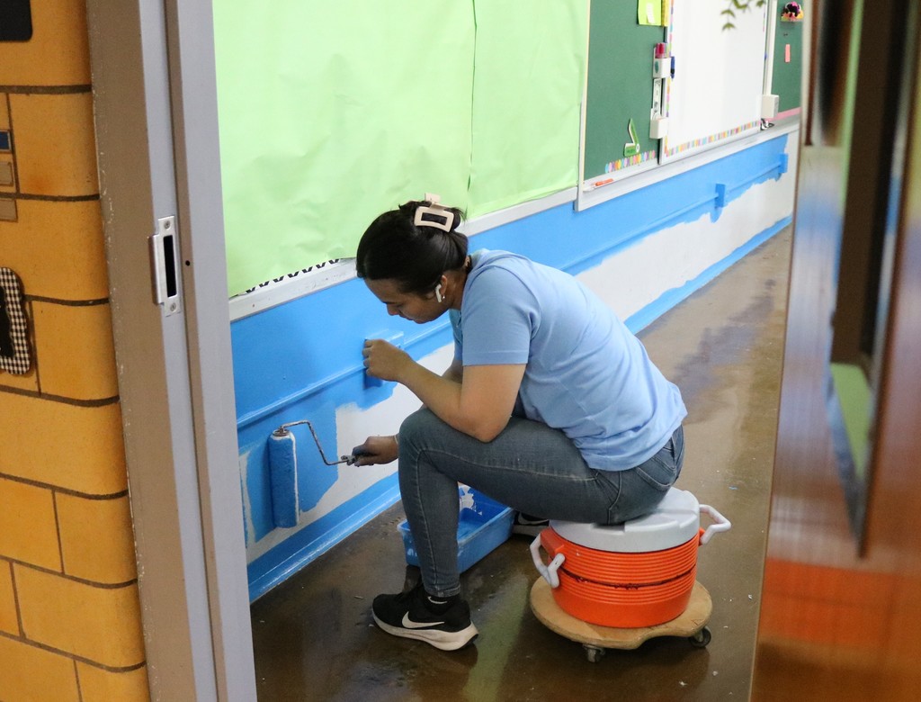 Woman painting classroom
