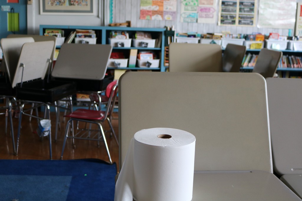 Classroom desks and roll of cleaning wipes