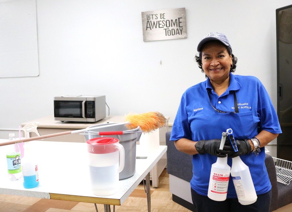 Custodian smiles for camera