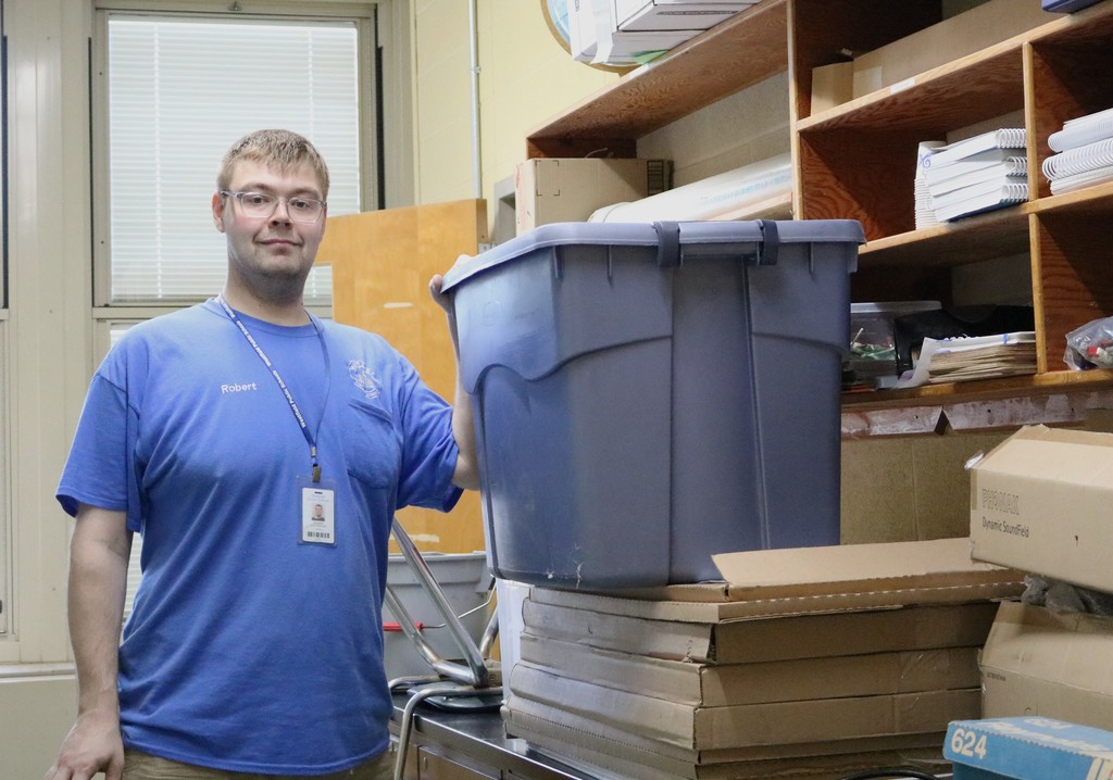 Custodian smiles for camera