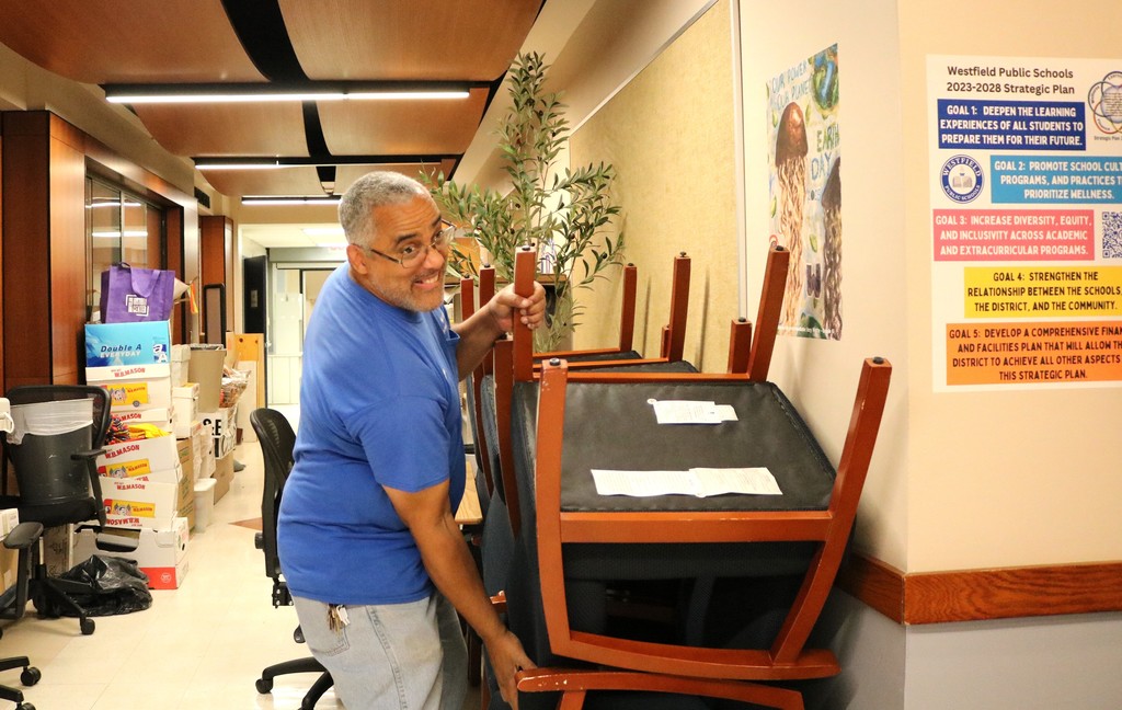 Custodian lifts chair at RIS