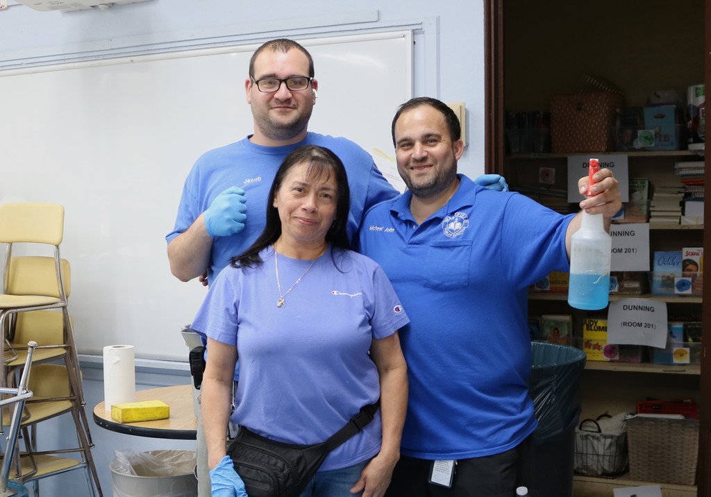 Three custodians pose for picture
