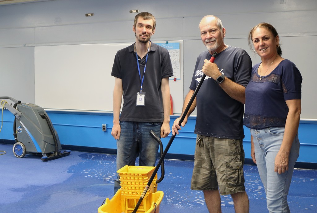 Three custodians pose for picture