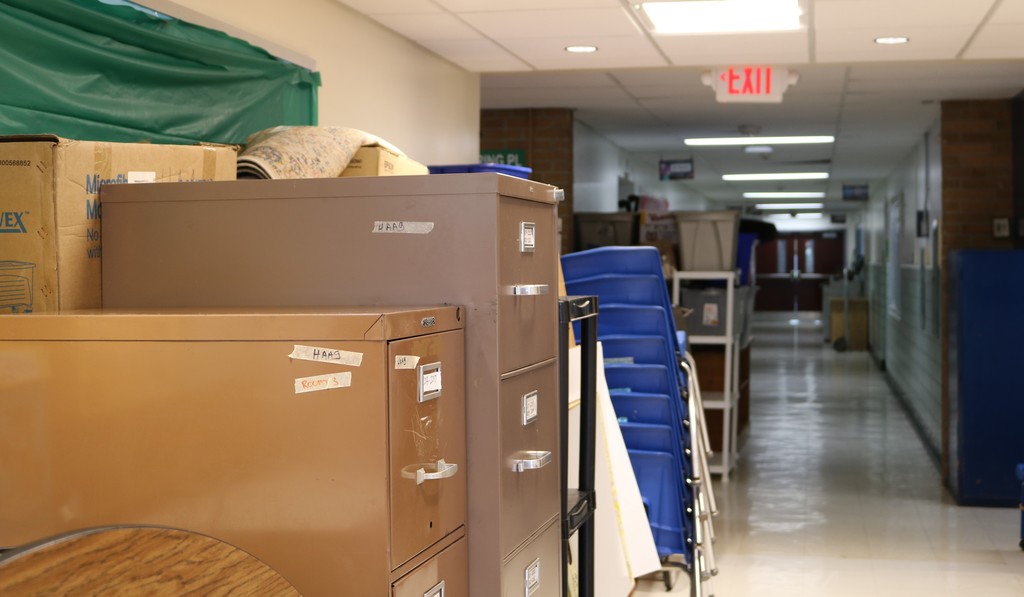 cabinets, chairs, other items neatly stacked in hallway