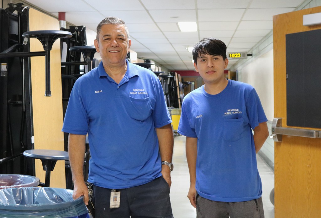 Two custodians pose for picture