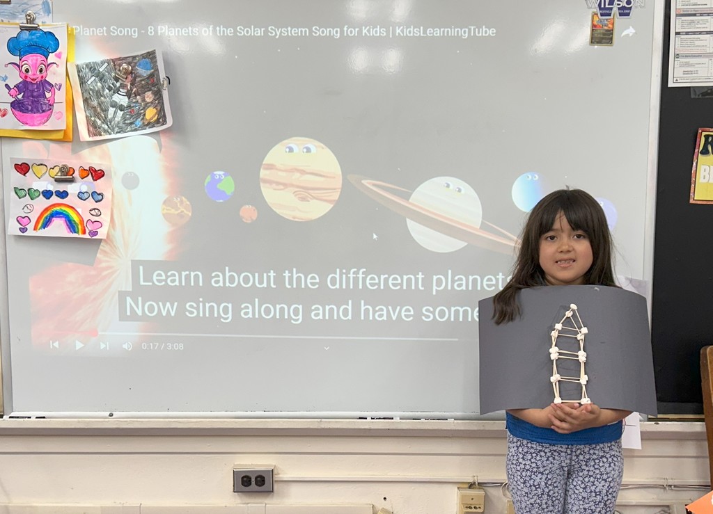 Student holds up solar system design