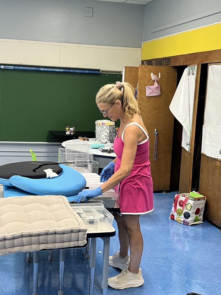 One of our teachers is setting up the classroom for her students. 