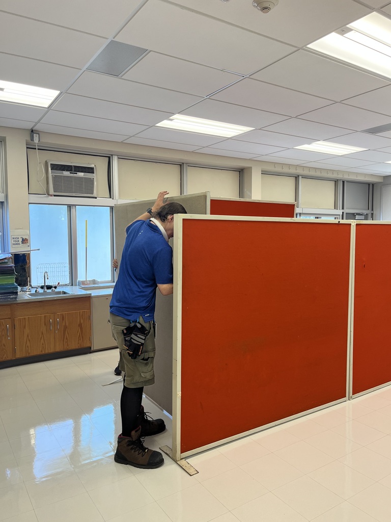 Our head custodian is moving the portable walls to make space for our teacher work areas. 