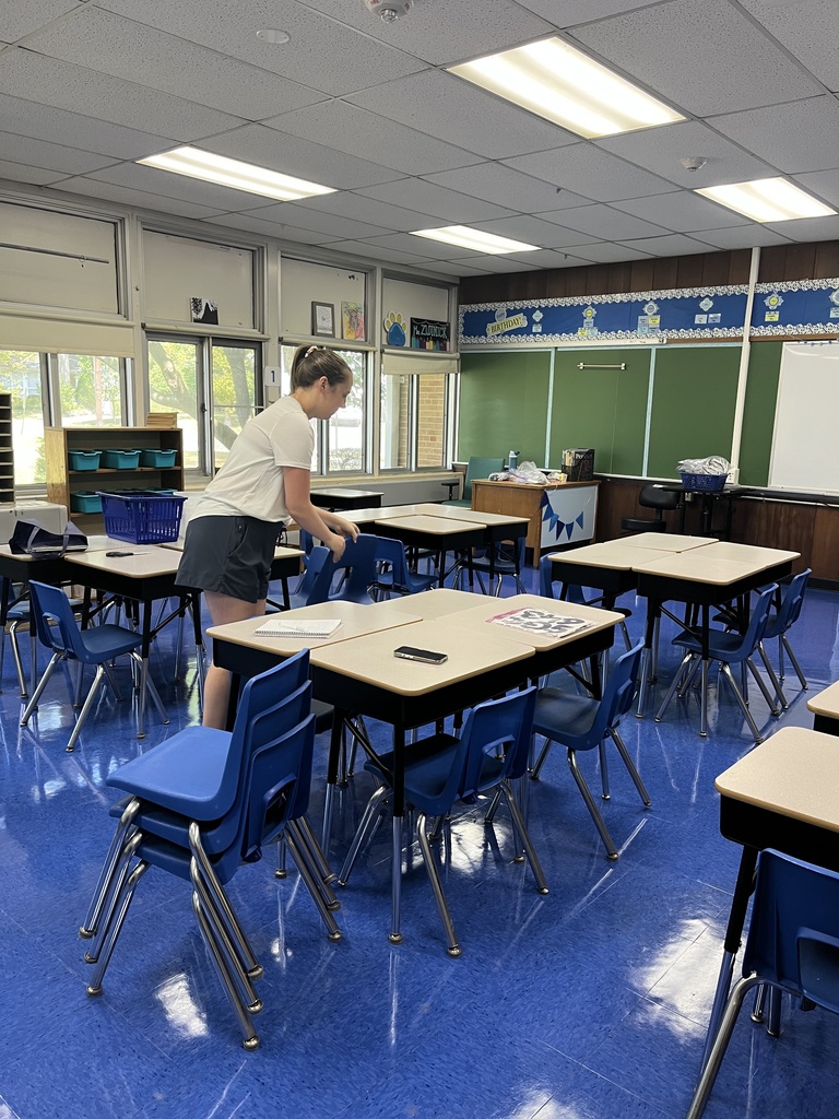 One of our teachers is setting up the classroom for her students. 