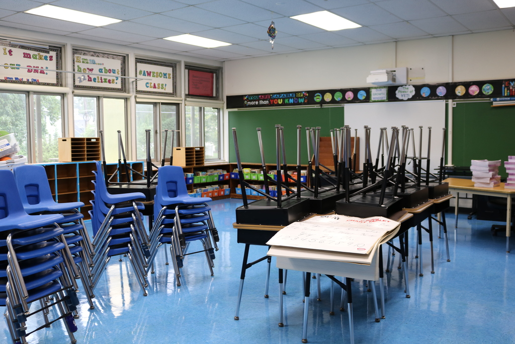 Classroom with chairs and desks stacked