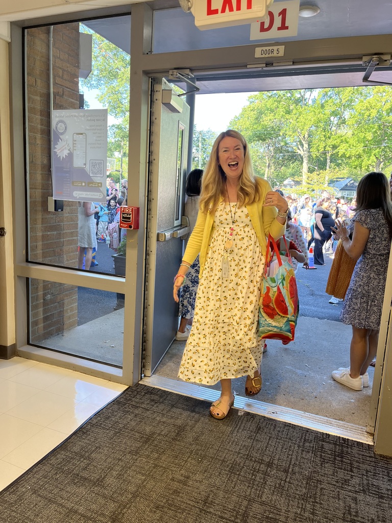 1st grade teacher super excited to start her day with her new class.