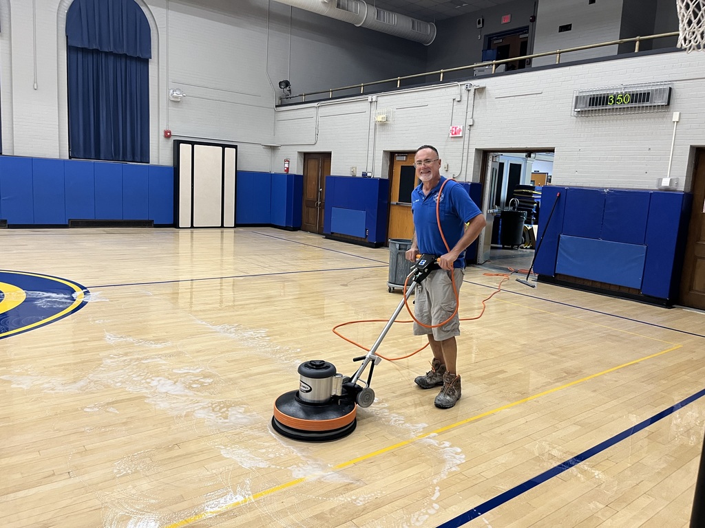 Custodian cleaning the gym floor