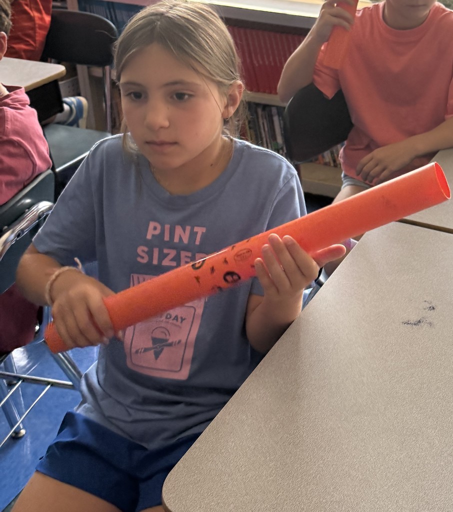 fourth grade student playing boomwhackers during music class